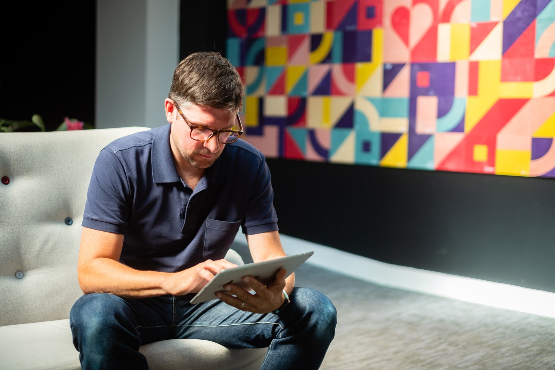 Uniform colleague reading a booklet in the studio lounge