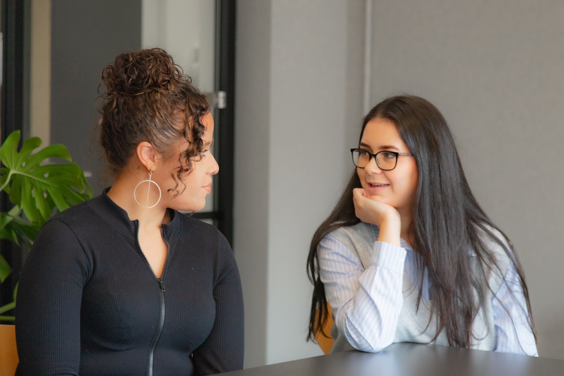 Two Uniform colleagues sharing a conversation at a studio table