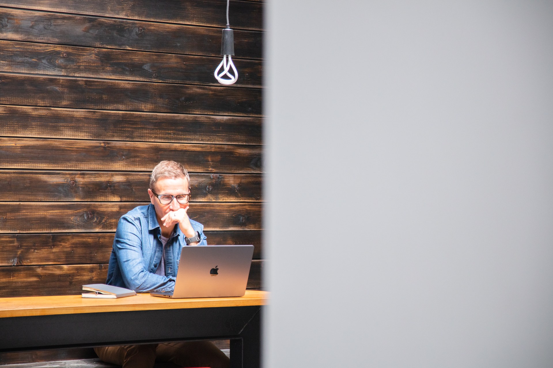 Uniform colleague working on a laptop in a quiet studio space